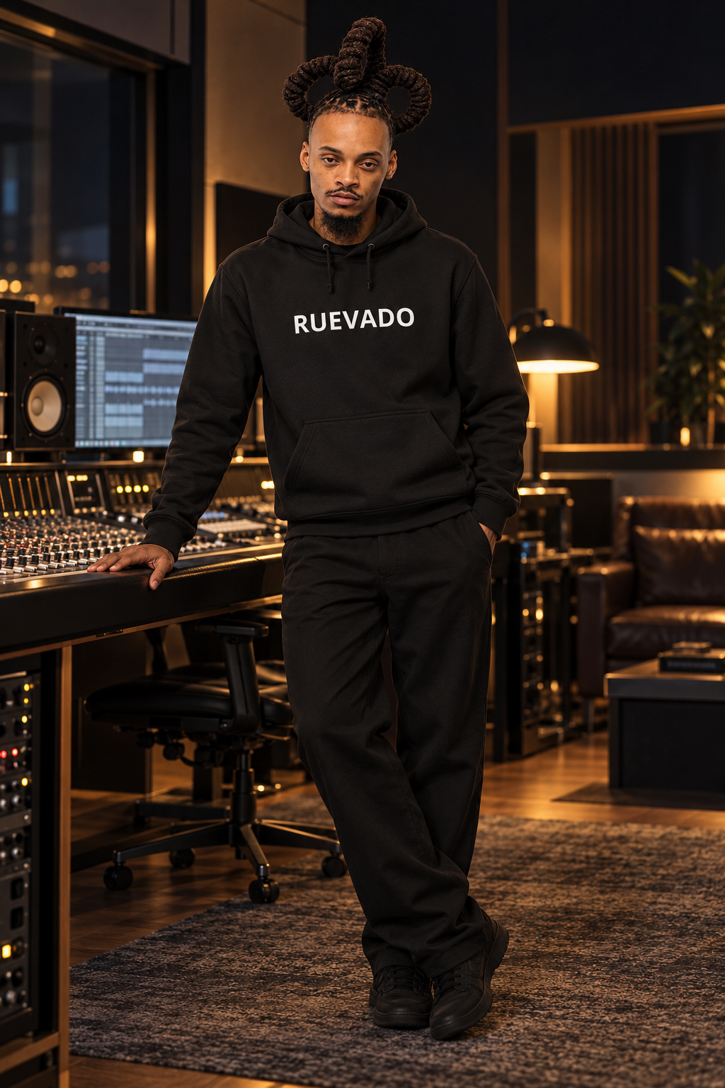 AI concept: Rue with his three-loop loc hairstyle in the black After Hours RUEVADO hoodie beside a studio desk.